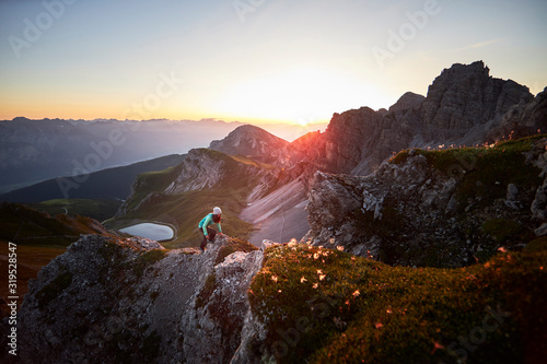 Woman climbing mountain ridge at Axamer Lizum, Austria photo