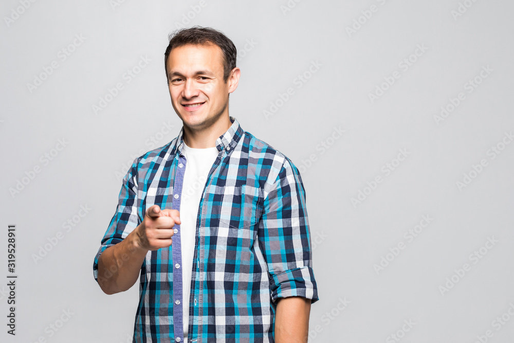 Portrait of a handsome young man pointing forward isolated on white background Portrait of a handsome young man pointing forward isolated on white background