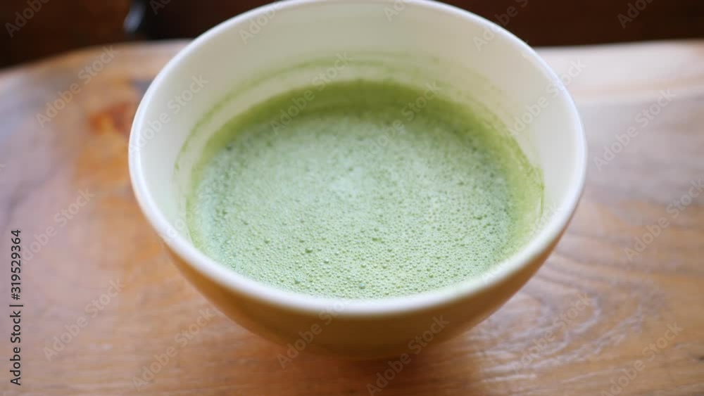 Close Up Of A Cup Of Matcha Latte. View From Above. 4K Slow Motion Footage. Close Up Of A Cup Of Matcha Latte. View From Above. 4K Slow Motion Footage.