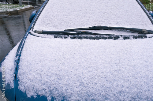 Blue car covered with snow. Fragment. Winter scene. Copy space for text.