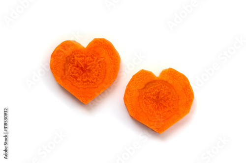 Carrot. 2 slices in heart shape isolated on white background. Difference versus similarity concept. Couple relationship concept.