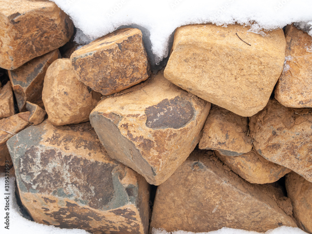 stone wall covered with snow in winter stone wall covered with snow in winter