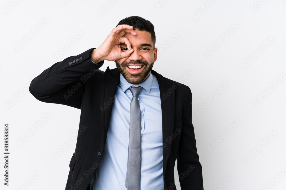Young latin business woman against a white background isolated excited keeping ok gesture on eye. Young latin business woman against a white background isolated excited keeping ok gesture on eye.