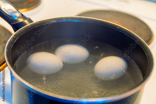 History of making a quick Breakfast. Chicken eggs are cooked in a pan on the stove. Moscow, Russia.