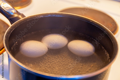 History of making a quick Breakfast. Chicken eggs are cooked in a pan on the stove. Moscow, Russia.