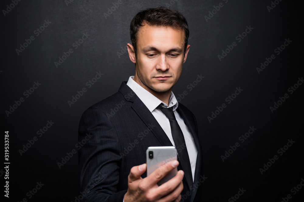 Portrait of cheerful businessman in suit surfing in internet Isolated on black background. Portrait of cheerful businessman in suit surfing in internet Isolated on black background.