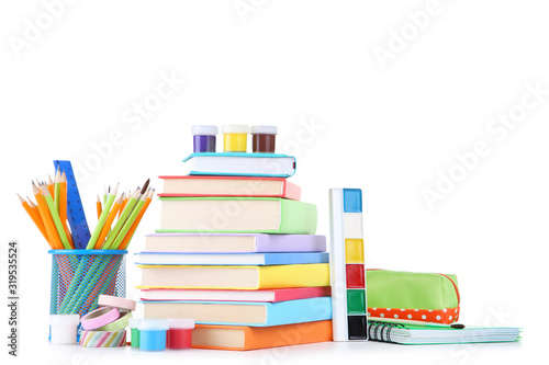School supplies with stack of books on white background