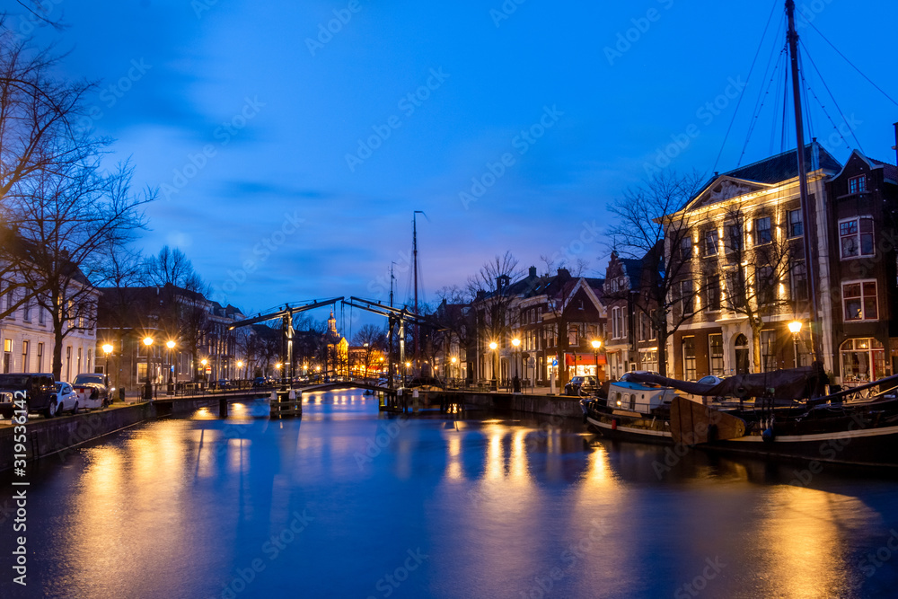 The center of Schiedam with beautiful narrow streets and small canals, photo taken in the evening hours with beautiful blue colors. Province south-Holland