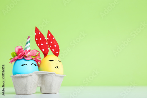 Cute easter eggs on green background