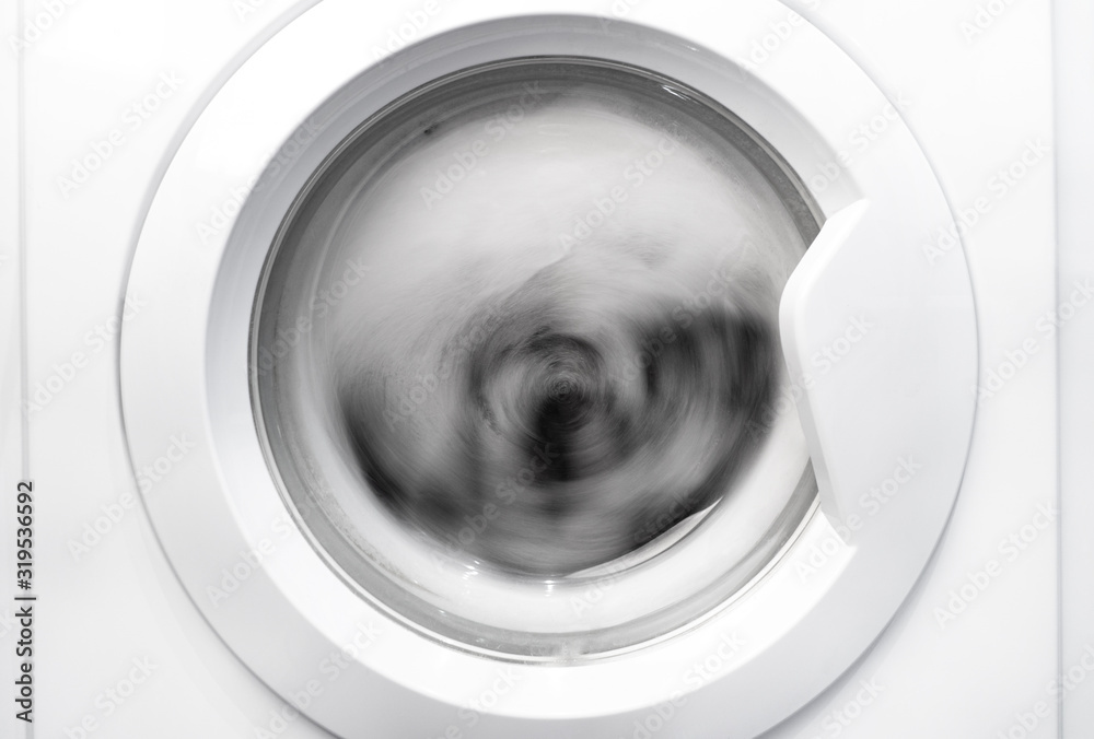 Clothes are wrung out in a drum of the washing machine. Clothes are wrung out in a drum of the washing machine.