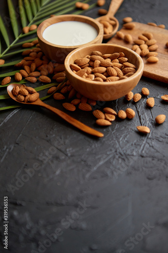 Close up of Almonds in wooden bowl and almond milk