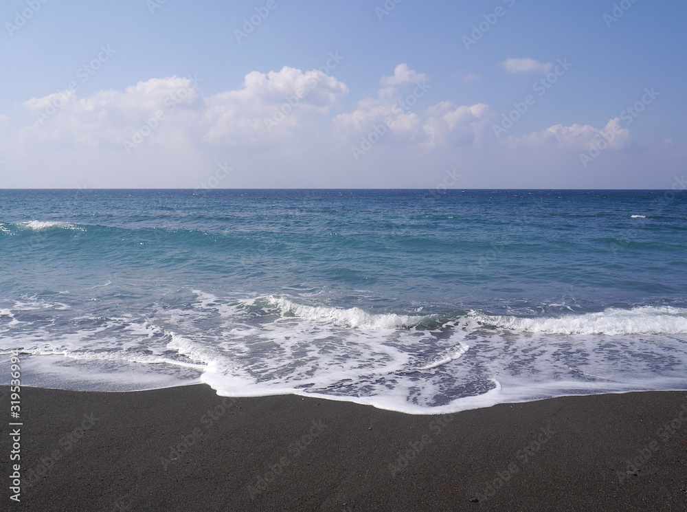 Seascape on the island of Santorini, Greece. Sea waves with foam on a sunny day. Seascape on the island of Santorini, Greece. Sea waves with foam on a sunny day.
