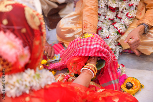 Colourful traditional view of bengali wedding rituals while groom and bride is taking oath in india