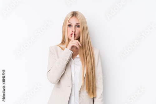 Young business blonde woman on white background keeping a secret or asking for silence.