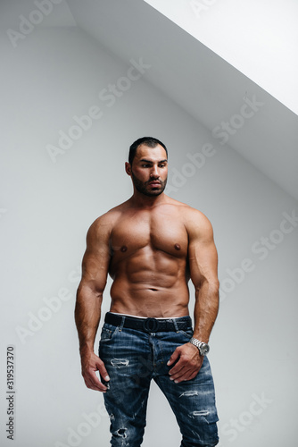 Sexy athlete posing topless in the studio. Fitness. Press. Sport.