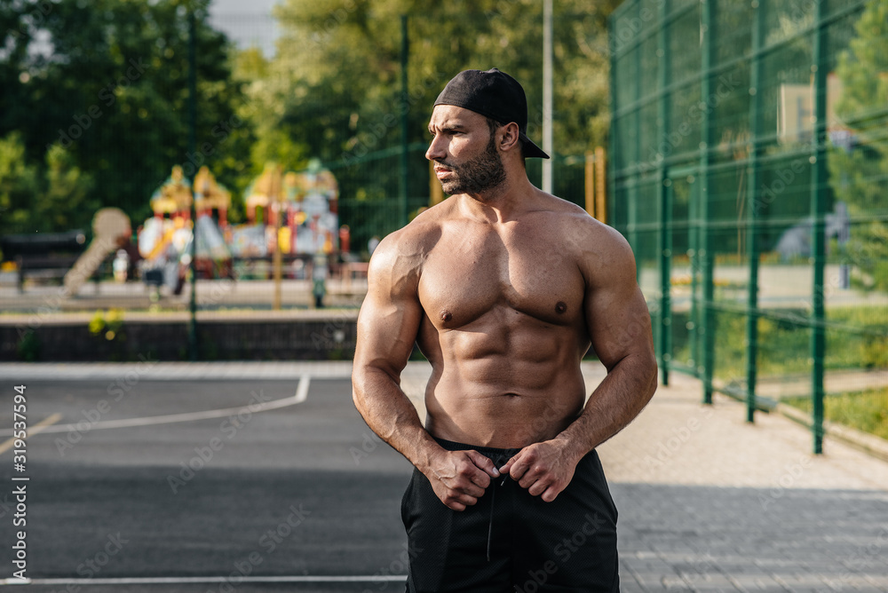 Sexy fitness sportsman posing on a sports field topless. Fitness, bodybuilding, healthy lifestyle Sexy fitness sportsman posing on a sports field topless. Fitness, bodybuilding, healthy lifestyle