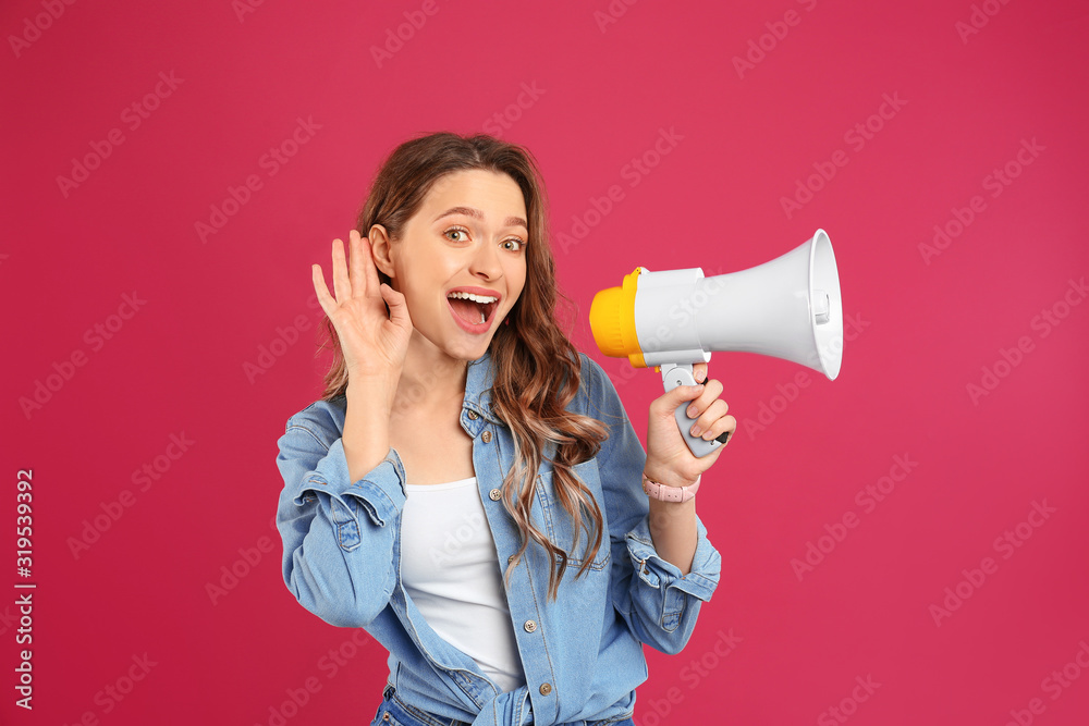 Young woman with megaphone on pink background Young woman with megaphone on pink background