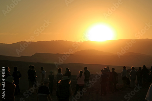 Silhouette of a lot of Traveler Watching the Awesome Sunset at Moon Valley in Atacama Desert  Northern Chile