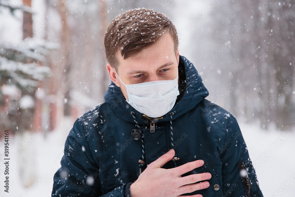 Alarmed male traveler wears medical mask to protect against coronavirus, afraid of infection. Deadly coronavirus in China 2019 2020 2019-nCoV