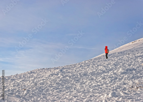 Woman looking into distance in Kasprowy Wierch in Zakopane in winter. Zakopane is a town in Poland in Tatra Mountains.Kasprowy Wierch is a mountain in Zakopane and the most popular ski area in Poland