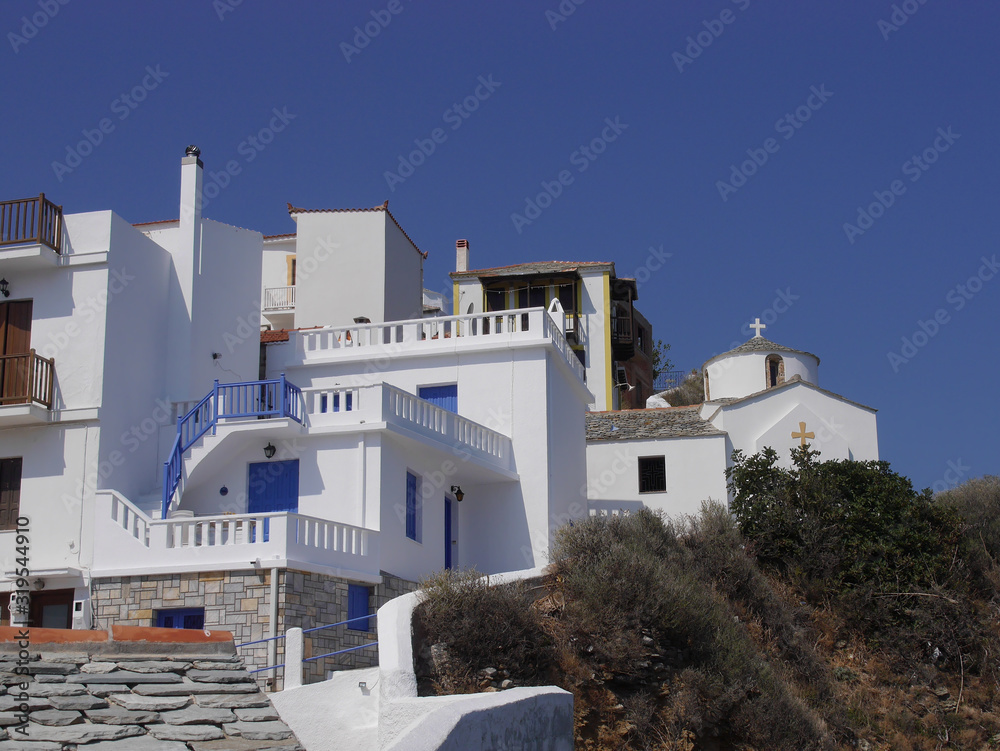 View of the Church in the old town, old streets and houses of the city of Skopelos on the island of Skopelos Greece.