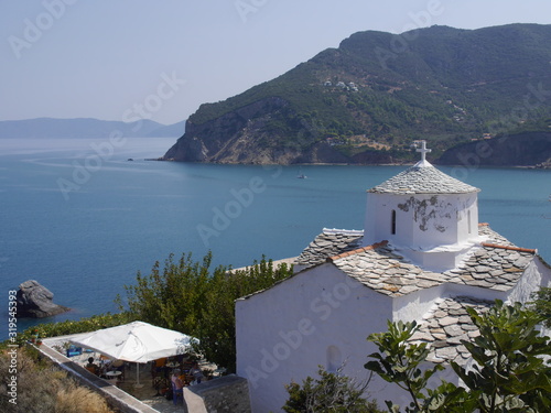 Fototapeta Naklejka Na Ścianę i Meble -  View of the Church in the old town, old streets and houses of the city of Skopelos on the island of Skopelos, Greece.