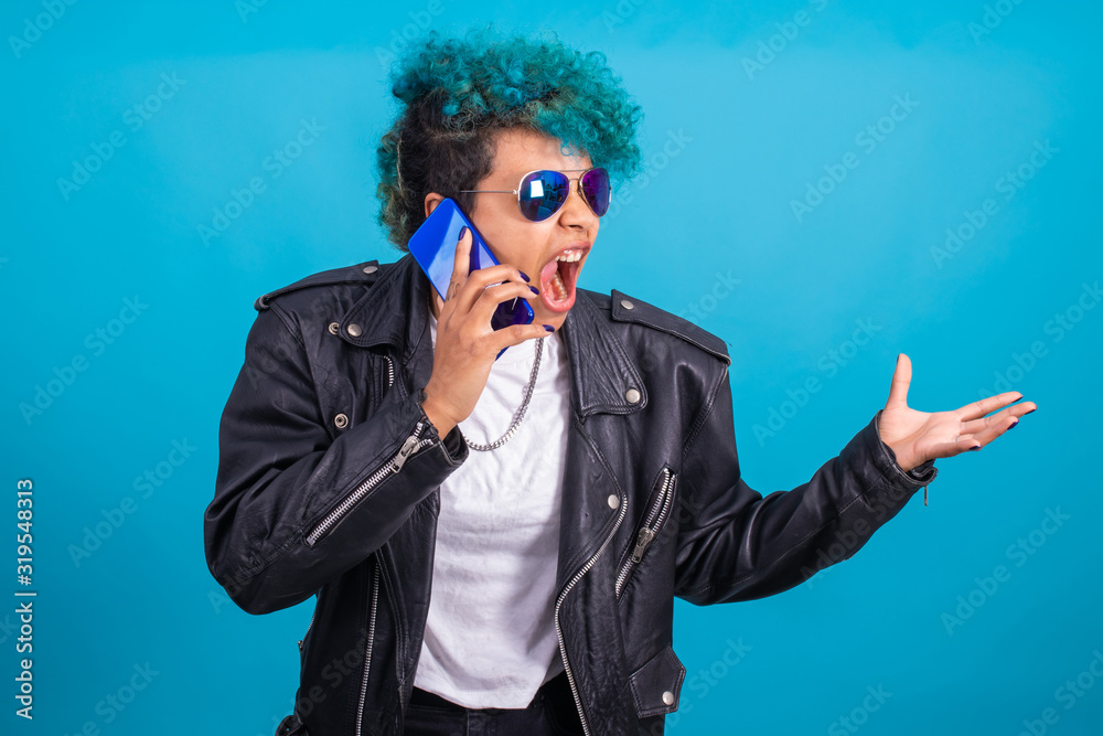 urban style modern girl with smart phone and sunglasses isolated on blue background