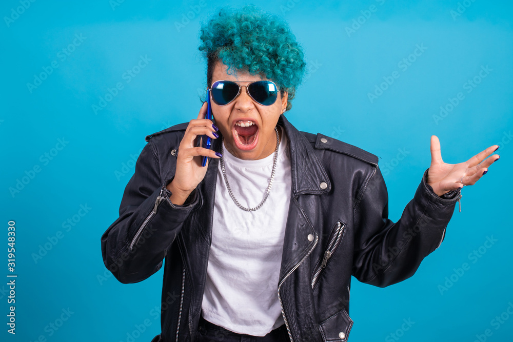 urban style modern girl with smart phone and sunglasses isolated on blue background urban style modern girl with smart phone and sunglasses isolated on blue background