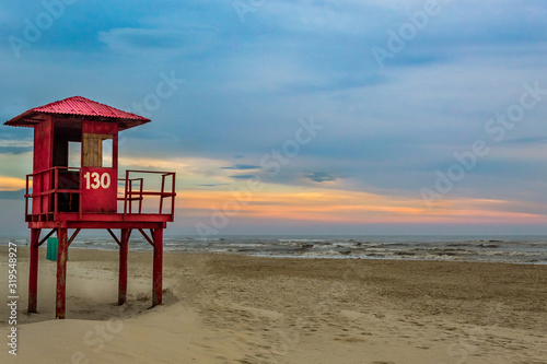 lifeguard tower on the beach at sunset