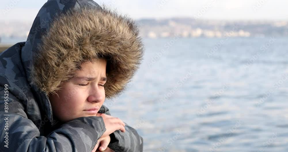 Portrait Of A Young Handsome Sad Teenage Boy Sitting At The Seaside Portrait Of A Young Handsome Sad Teenage Boy Sitting At The Seaside