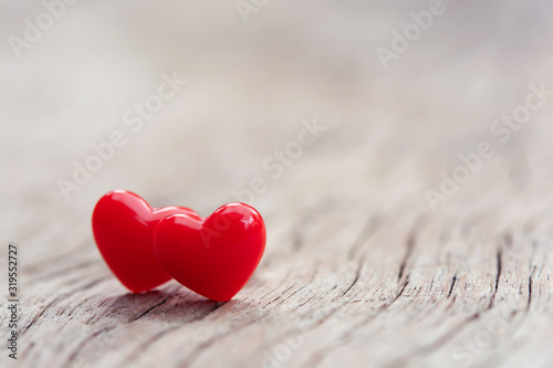 Valentines Day concept - Red hearts on plank wooden background with copy space.