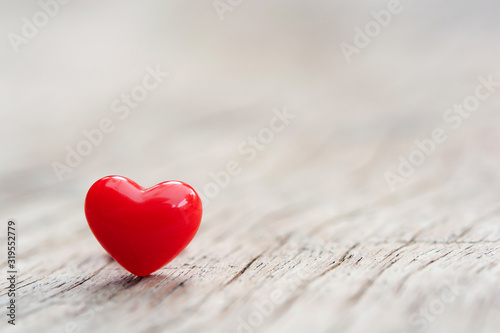 Valentines Day concept -  Red hearts on plank wooden background with copy space.