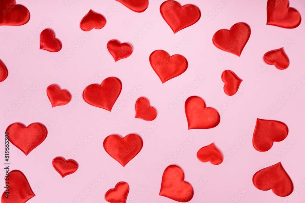Many of red hearts on pink paper background for Valentines day