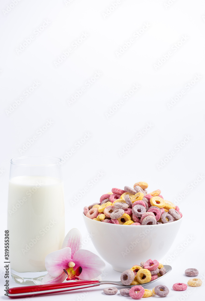 Corn cereal breakfast flake in children cups and milk is a healthy breakfast that is good for your body every day on a white background. Corn cereal breakfast flake in children cups and milk is a healthy breakfast that is good for your body every day on a white background.