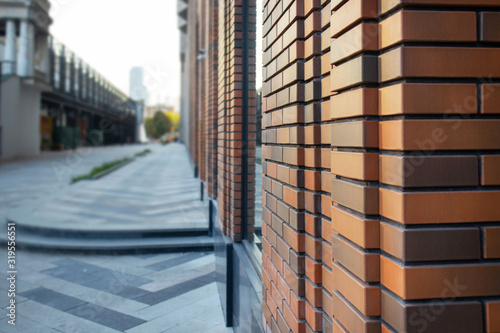 Close up view of red brick facade wall. Modern loft building from red brick in downtown area. Industrial design in city architecture. .. photo
