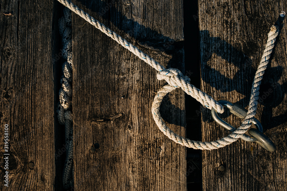rope tied with a fixed knot and metal carabiner