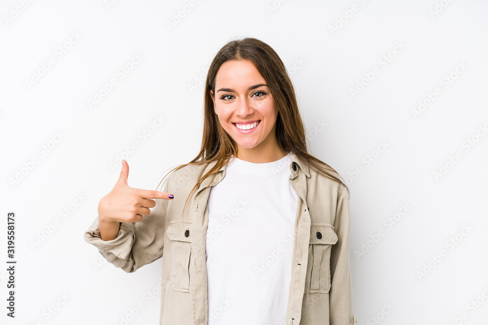 Young caucasian woman isolated person pointing by hand to a shirt copy space, proud and confident Young caucasian woman isolated person pointing by hand to a shirt copy space, proud and confident