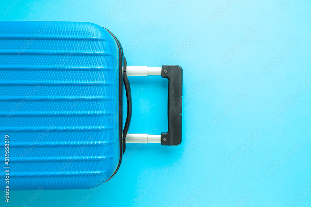 Obraz premium Flat lay of luggage on blue background vacation concept.