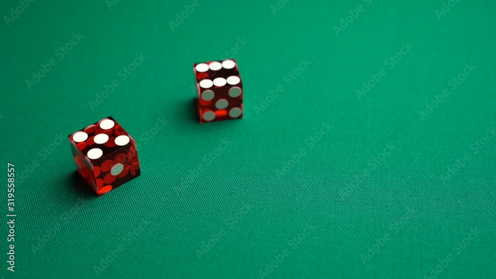 The shooter rolls eleven in craps. Slow motion two red dice, craps, thrown on green tomentum background at casino, Easy ten. Gambling game with random result for adults. The shooter rolls eleven in craps. Slow motion two red dice, craps, thrown on green tomentum background at casino, Easy ten. Gambling game with random result for adults.