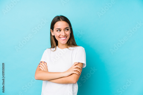 Young caucasian woman isolated smiling confident with crossed arms.
