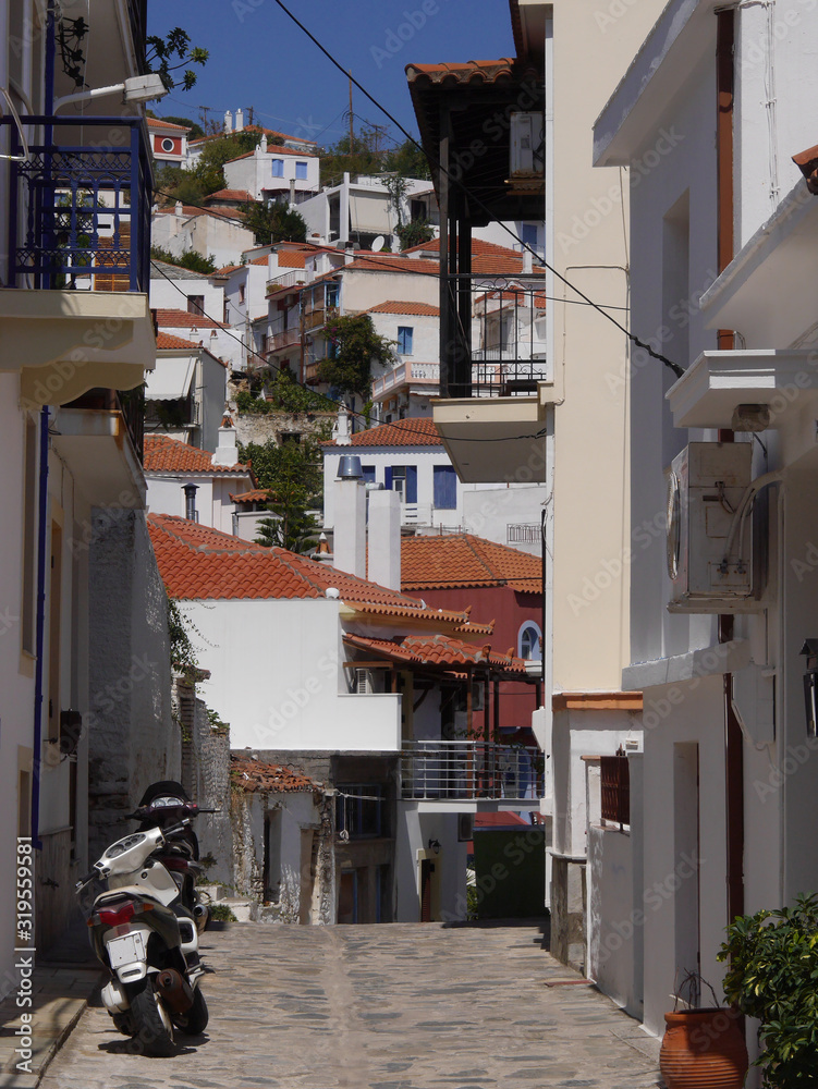 Panorama on the red tiled roofs and houses of the old town of Skopelos on Skopelos island, Greece.