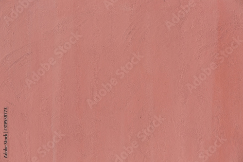 The concrete wall is a pale pink color. Background texture. © Amir