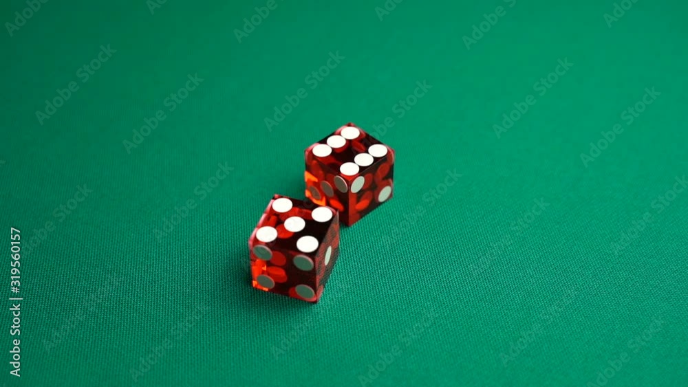 The shooter rolls eleven in craps. Slow motion two red dice, craps, thrown on green tomentum background at casino, Yo or Yo-leven. Gambling game with random result for adults. The shooter rolls eleven in craps. Slow motion two red dice, craps, thrown on green tomentum background at casino, Yo or Yo-leven. Gambling game with random result for adults.