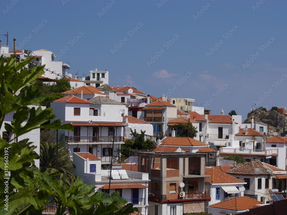Panorama on the red tiled roofs and houses of the old town of Skopelos on Skopelos island, Greece.