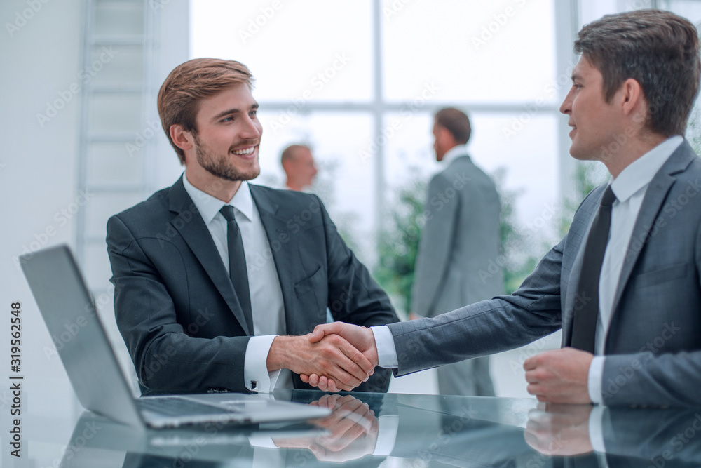 close up. handshake of business people at the Desk close up. handshake of business people at the Desk