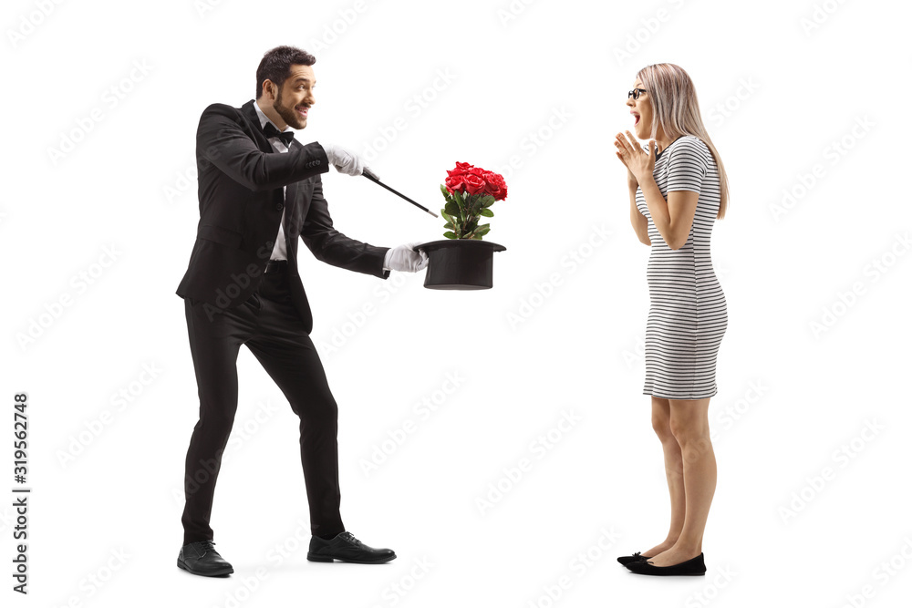 Magician making a magic trick with flowers and a hat in front of a surprised young woman Magician making a magic trick with flowers and a hat in front of a surprised young woman