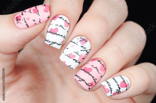 White pink manicure on St. Valentine s Day with pattern letter and hearts