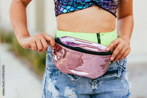 Brazilian Carnival. Young woman dressed for the carnival block. Closeup of fanny pack decorated with glitter. photo