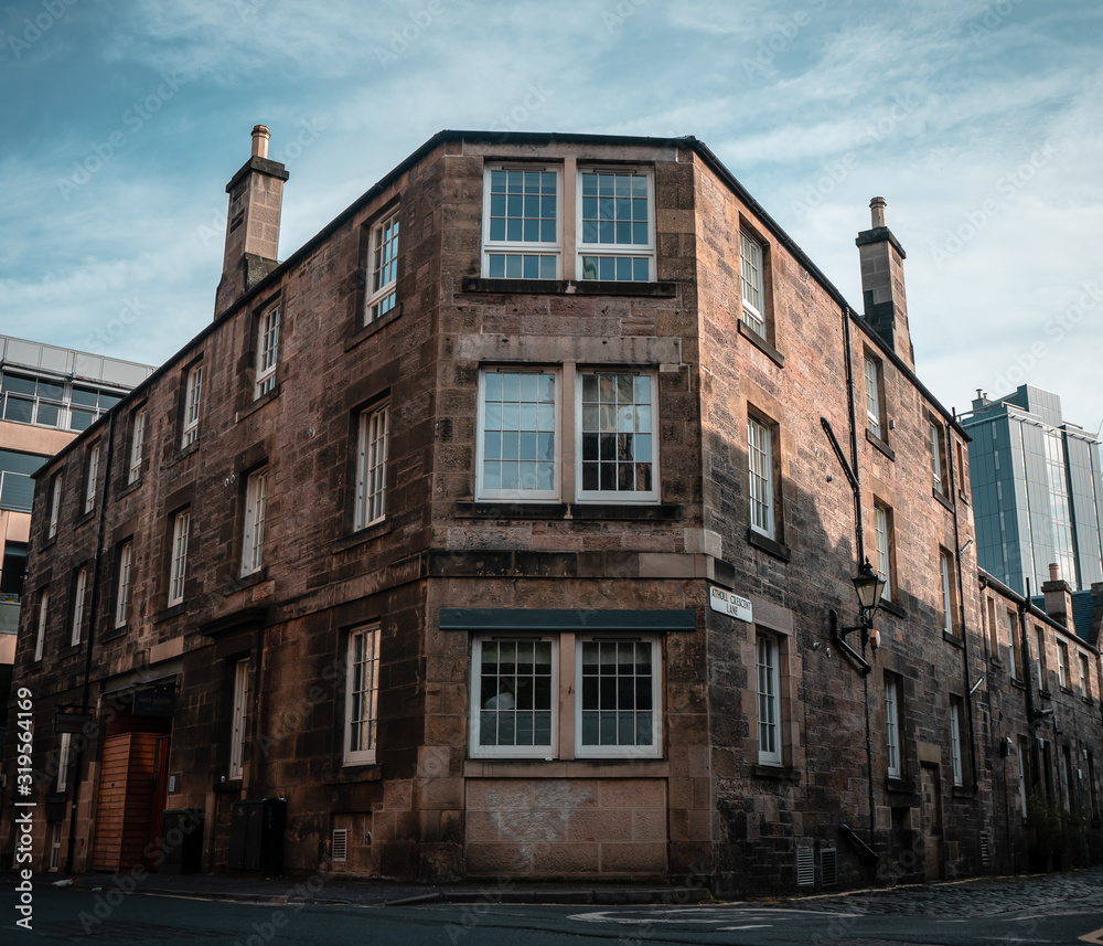 Old brick apartment building on a street corner in Edinburgh, Scotland