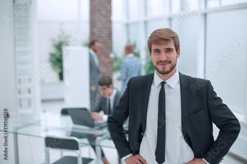 close up. smiling businessman standing in his office.